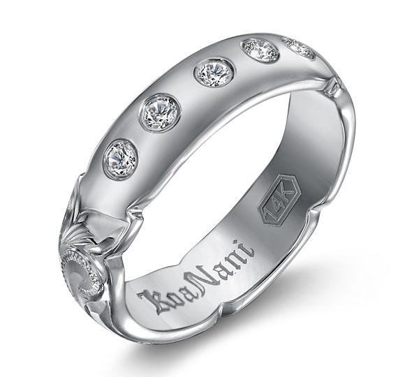 The picture shows a 14K white gold 5 mm ring with hand engravings and diamonds.