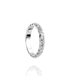 In this photo there is a white gold lei ring with hand engravings of a maile leaf.