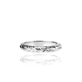 In this photo there is a white gold lei ring with hand engravings of a maile leaf.