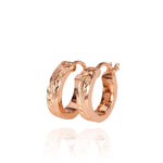 The picture shows a pair of 14K rose gold mini hoop earrings with scroll engraving.