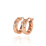 The picture shows a pair of 14K rose gold mini hoop earrings with scroll engraving.