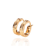 The picture shows a pair of 14K yellow gold mini hoop earrings with scroll engraving.