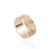 The picture shows a 14K yellow gold wave diamond channel 8mm ring with hand-engravings.