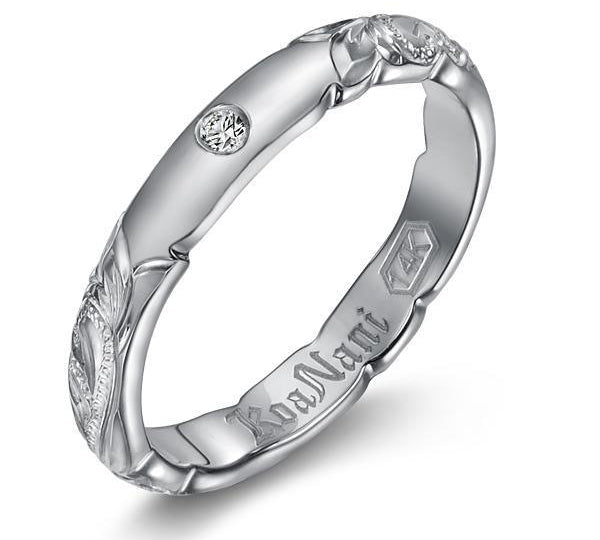 The picture shows a 14K white gold diamond 3mm ring with hand engravings and a diamond.