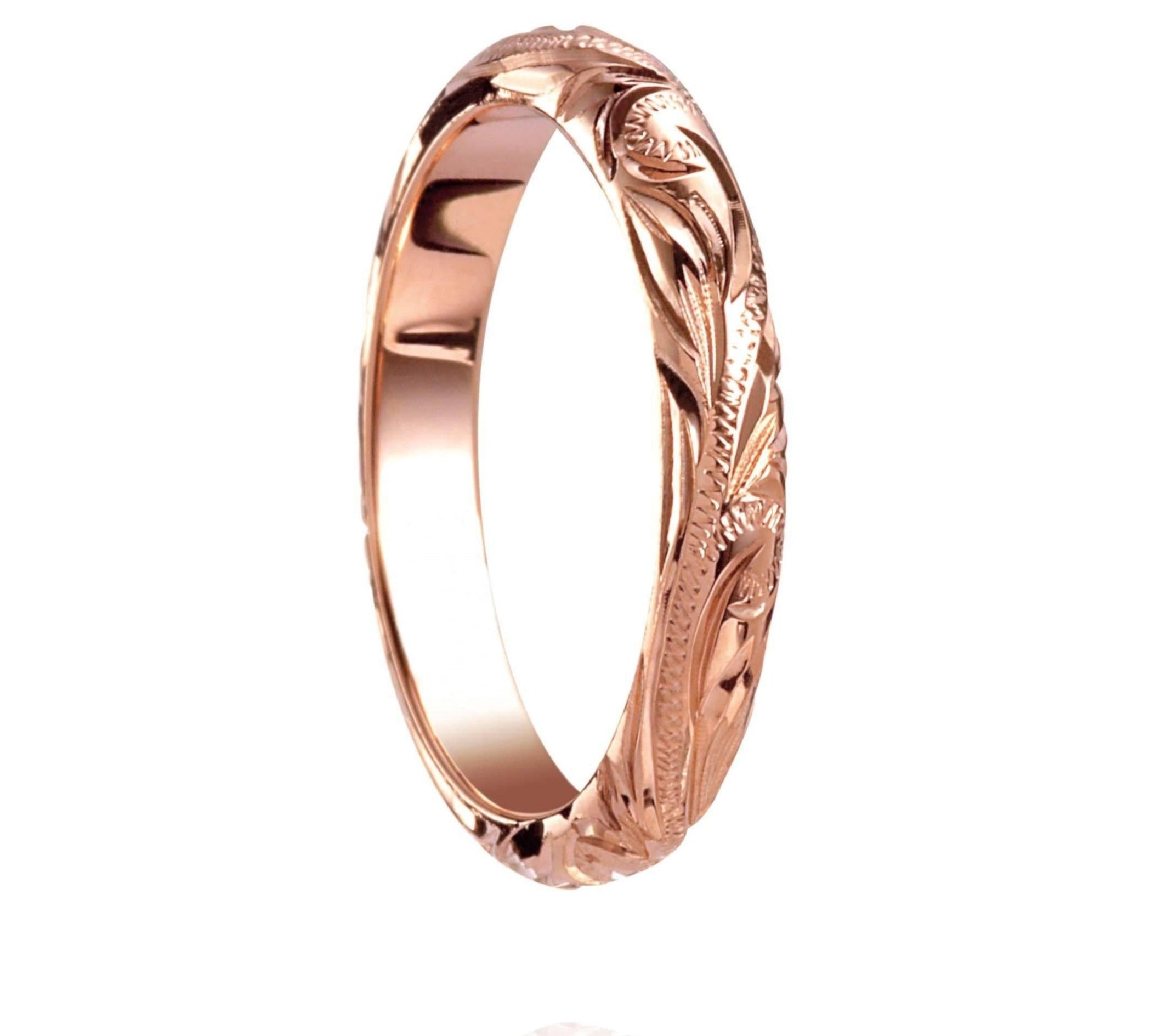The picture shows a 14K rose gold infinity ring with hand-engraved detailing.