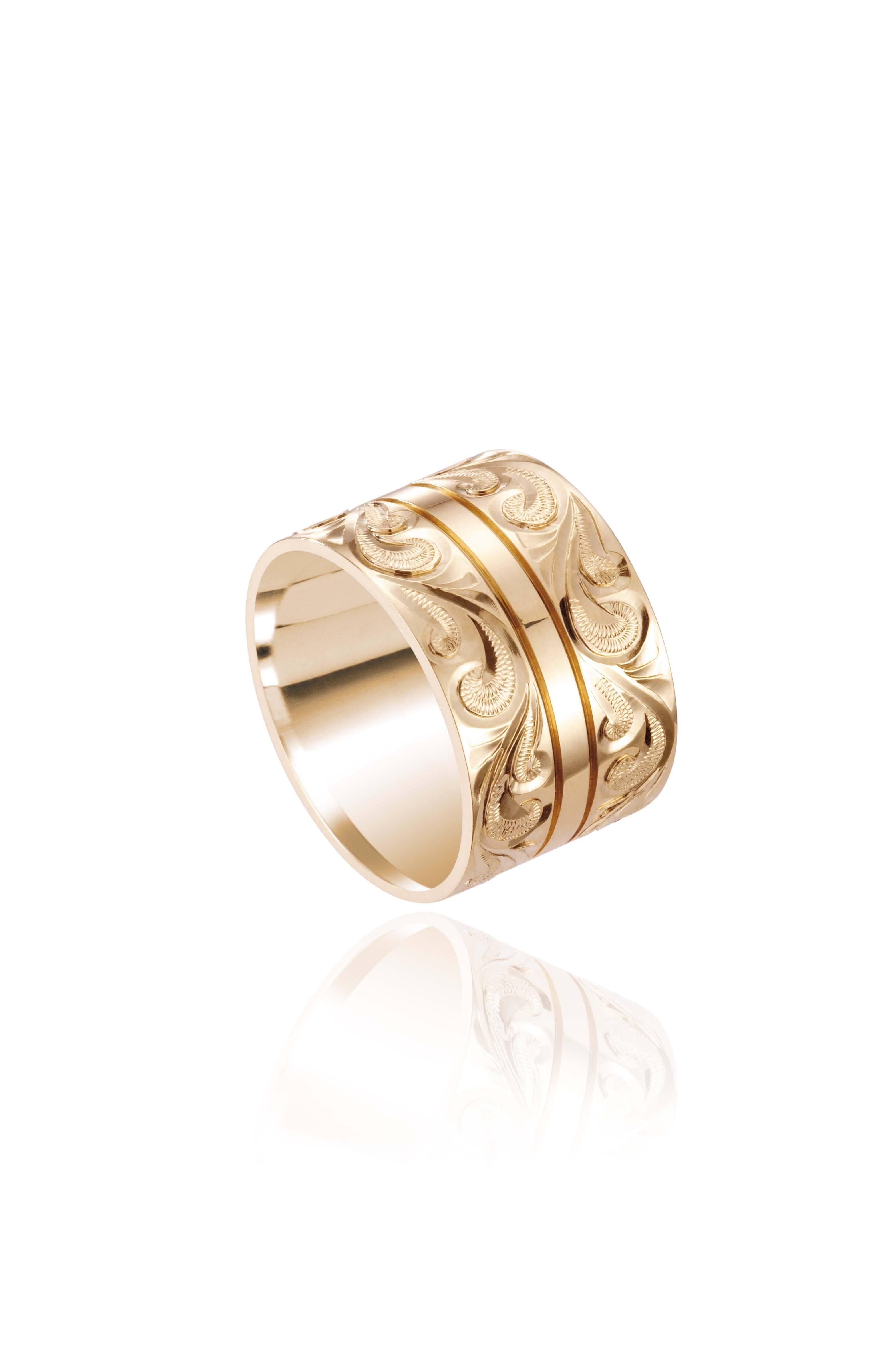 The picture shows a 14K yellow gold 12 mm ring with hand engravings.