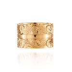 The picture shows a 14K yellow gold 12 mm ring with hand engravings.
