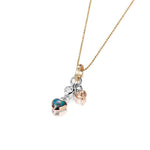The picture shows a 14K yellow, white, and rose gold opal two-heart charm pendant with hand engravings and a diamond.