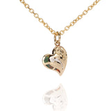 The picture shows a 14K yellow gold opal heart pendant with hand engravings.