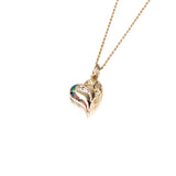 The picture shows a 14K yellow gold opal heart pendant with hand engravings.