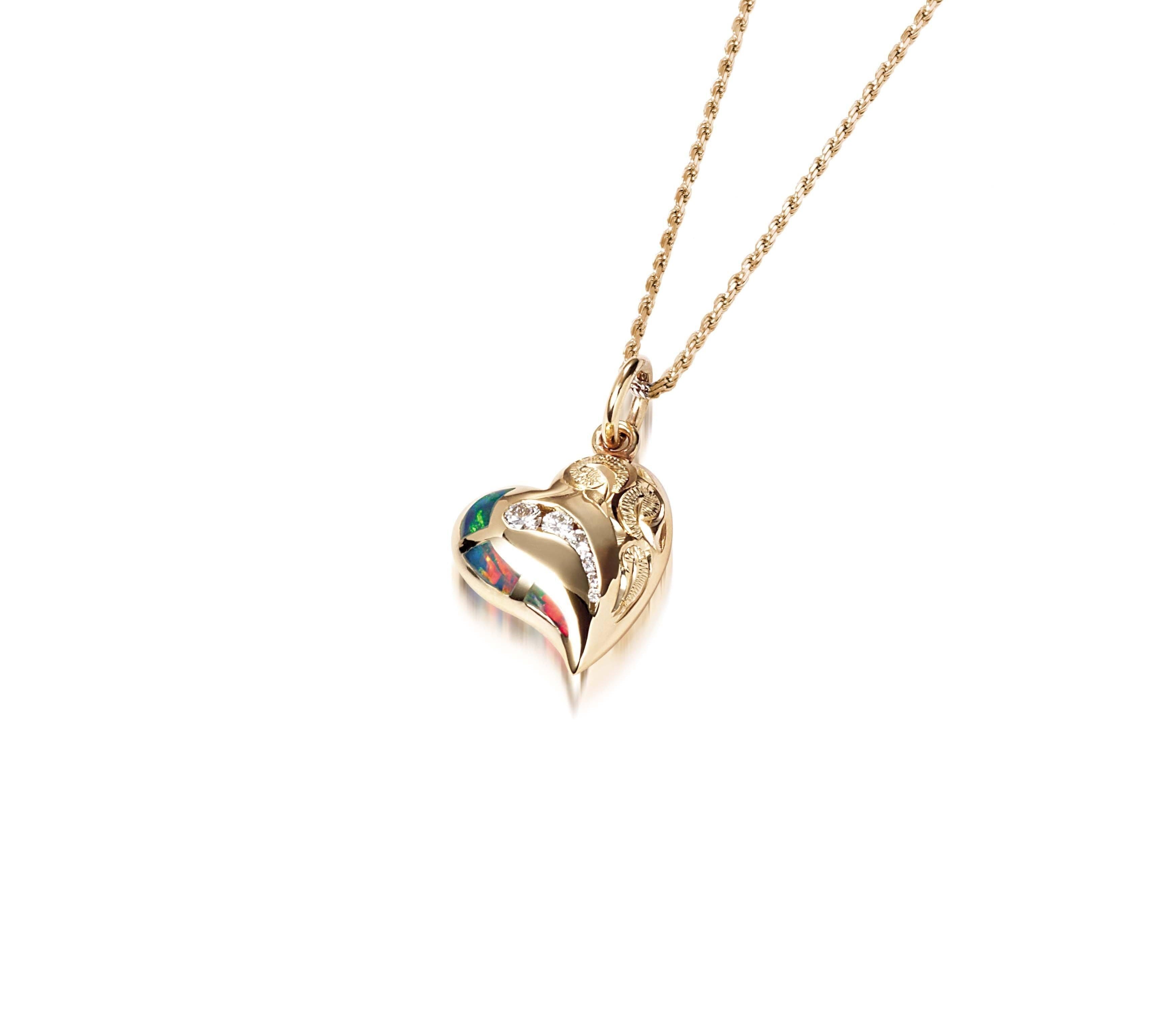 The picture shows a 14K yellow gold opal heart pendant with hand engravings.