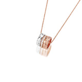 The picture shows a 14K rose, yellow, and white gold barrel pendant with diamonds.