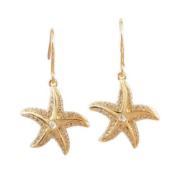 The picture shows a pair of 14K yellow gold pavé diamond starfish hook earrings.