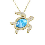 The picture shows a 14K yellow gold sea turtle pendant with a larimar gemstone and diamonds.