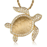 The picture shows a 14K yellow gold sea turtle pendant with diamonds.