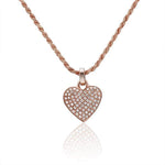 The picture shows a 14K rose gold pavé heart pendant with diamonds.