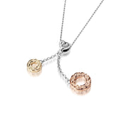 The picture shows a 14K rose and yellow gold two circles and one heart charm pendant with hand engravings.