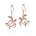 The picture shows a pair of 14K rose gold sea turtle hook earrings.