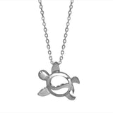 The picture shows a 14K white gold sea turtle wave necklace.
