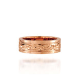 In this photo there is a rose gold ring with flower and scroll hand-engravings.