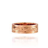 In this photo there is a rose gold ring with flower and scroll hand-engravings.