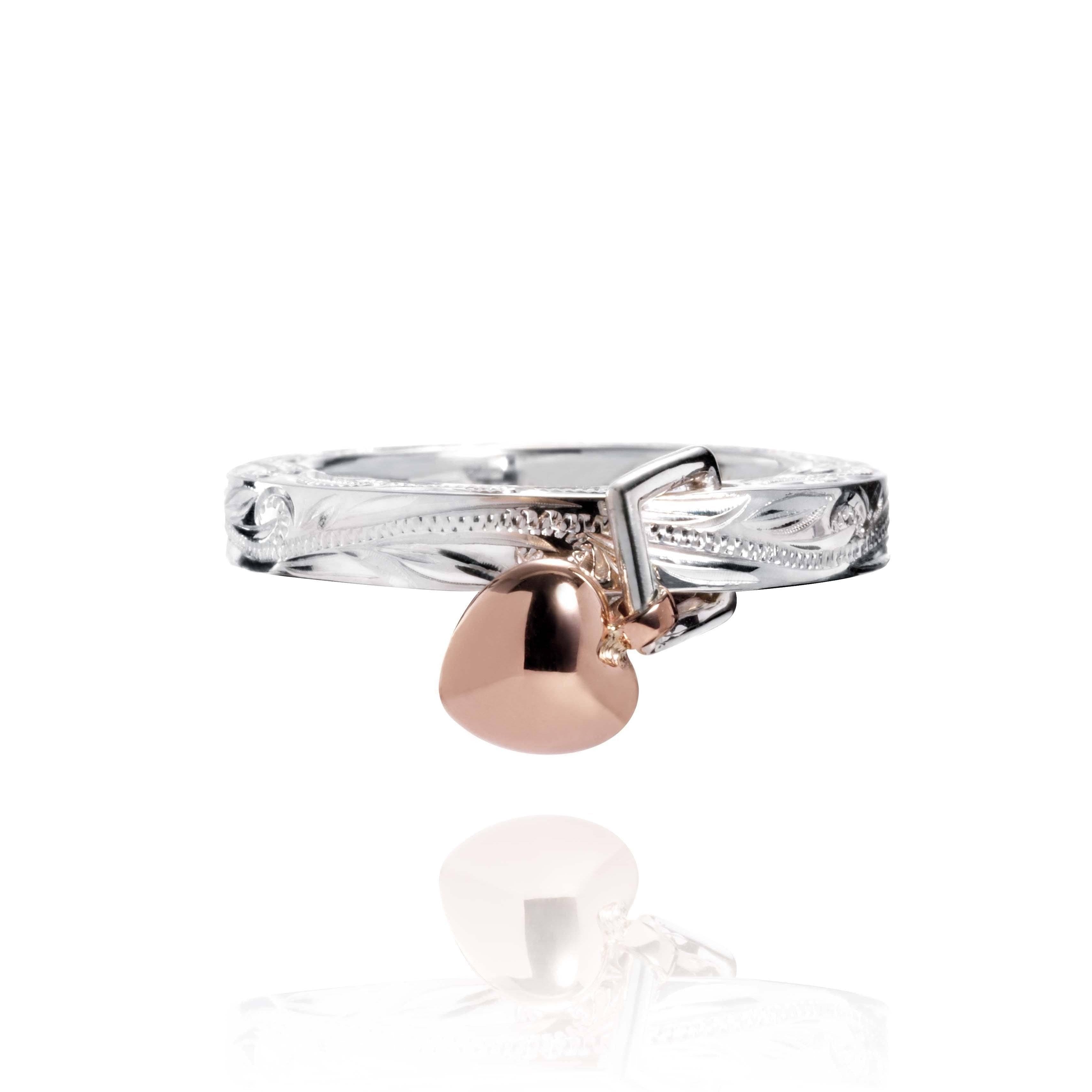 The picture shows a 14K rose gold and 925 sterling silver heart ring with hand engravings.