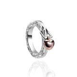 The picture shows a 14K rose gold and 925 sterling silver heart ring with hand engravings.