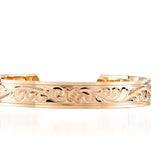 The picture shows a 14K yellow gold royal bangle with sea turtle engravings.