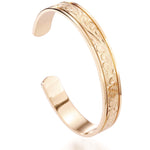 The picture shows a 14K yellow gold royal bangle with sea turtle engravings.