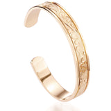 The picture shows a 14K yellow gold royal bangle with sea turtle engravings.