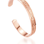 The picture shows a 14K rose gold royal bangle with plumeria engravings.