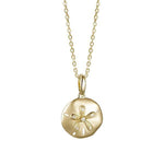The picture shows a small 14K yellow gold sand dollar pendant with diamonds.