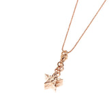 The picture shows a 14K rose gold star charm with paisley hand engravings.