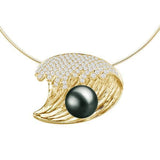 In this photo there is a yellow gold wave pendant with diamonds and one dark green pearl.