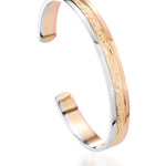 The picture shows a 14K white, yellow, and rose gold tri-color bangle with plumeria engraving.