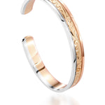 The picture shows a 14K white, yellow, and rose gold tri-color bangle with scroll engraving.