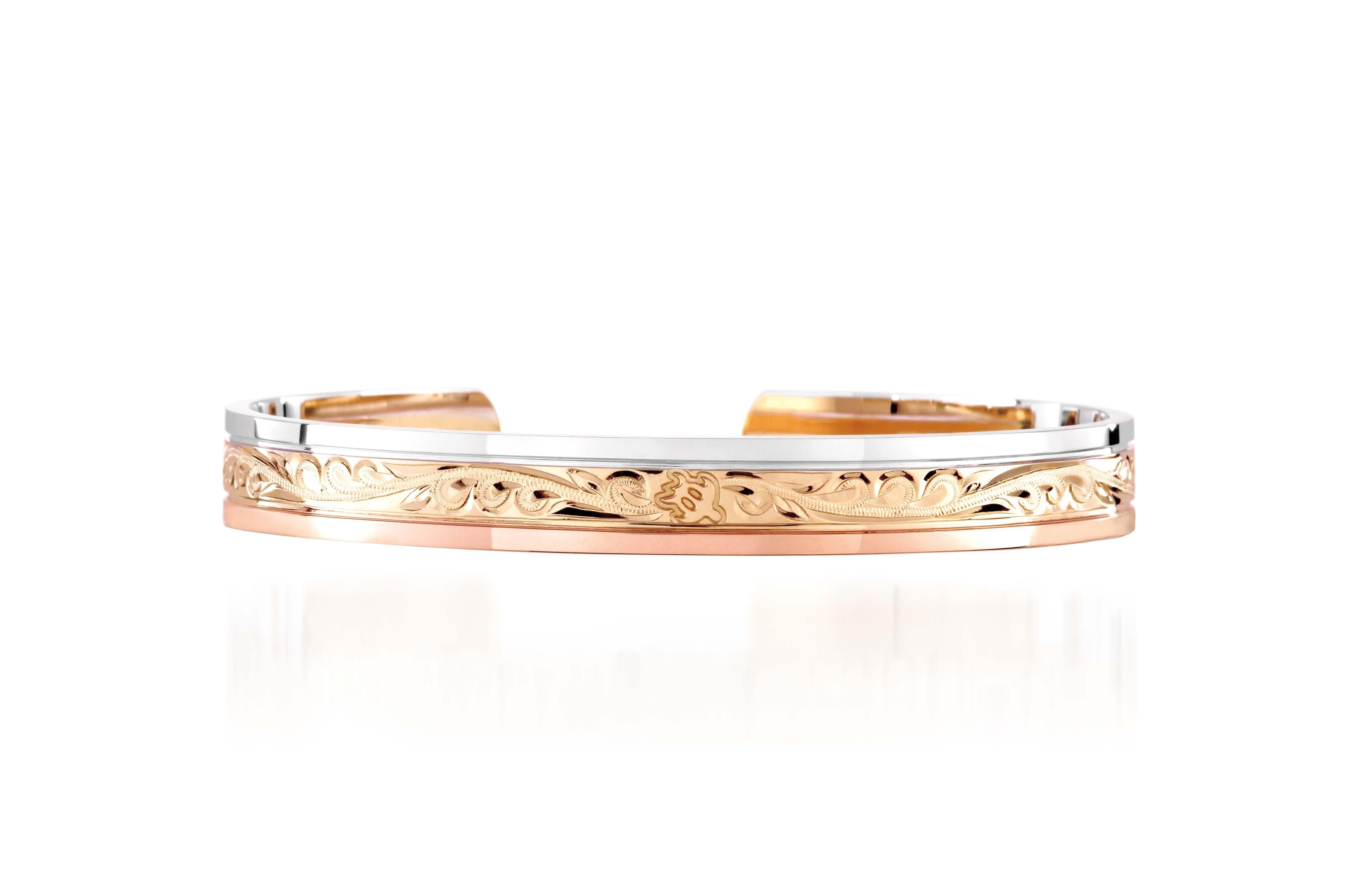 The picture shows a 14K white, yellow, and rose gold tri-color bangle with scroll engraving.