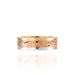 In this photo there is a yellow, rose, and white gold tricolor ring with flower and scroll hand engravings.