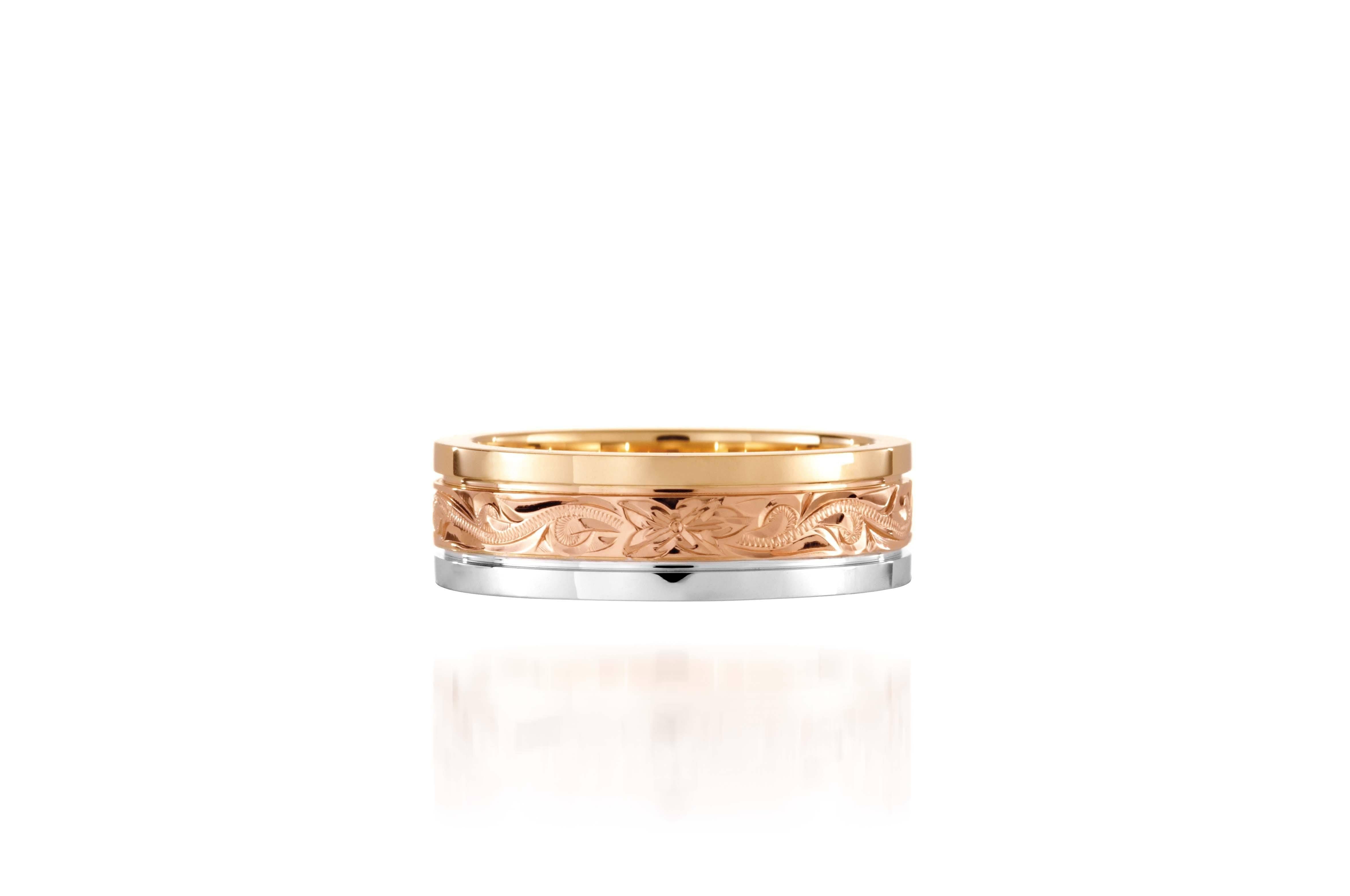 In this photo there is a yellow, rose, and white gold tricolor ring with flower and scroll hand engravings.