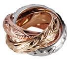 This picture shows a 14K white, yellow, and rose gold three ring pendant with engravings.