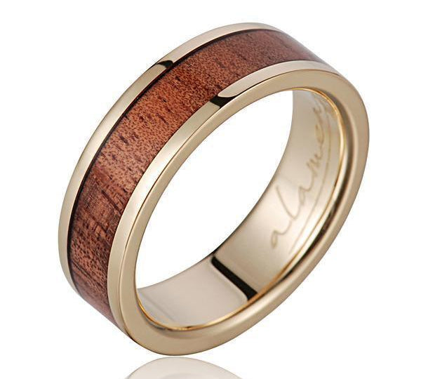 In this photo there is a 14K yellow gold and tulip poplar wood ring.