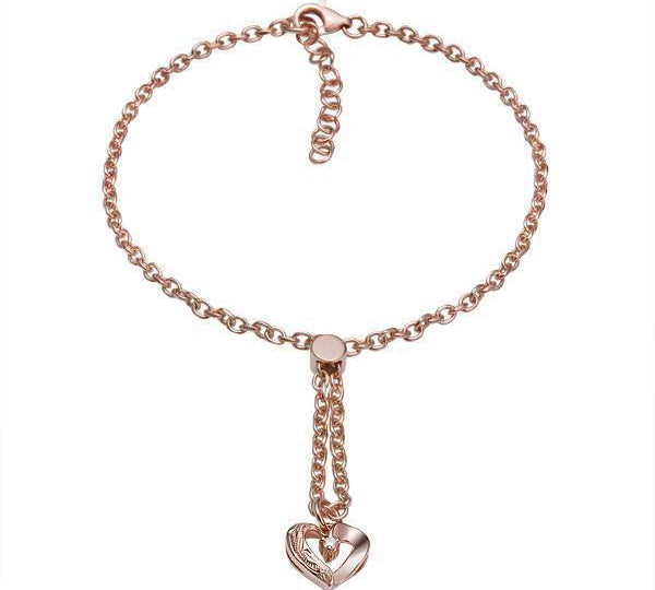 The picture shows a 14K rose gold heart bracelet with one diamond and hand-engravings.