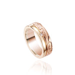 The picture shows a 14K yellow and rose gold two-tone pinched channel 6mm ring with a diamond, and hand-engravings.