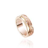 The picture shows a 14K yellow and rose gold two-tone pinched channel 6mm ring with a diamond, and hand-engravings.