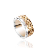 The picture shows a 14K white and yellow gold two-tone 8 mm channel ring with a diamond and hand-engravings.