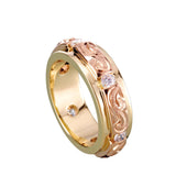 The picture shows a 14K yellow and rose gold two-tone infinity ring with diamonds and hand-engravings.