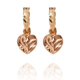 The picture shows a pair of 14K yellow and rose gold two-tone heart earrings with scroll engraving.