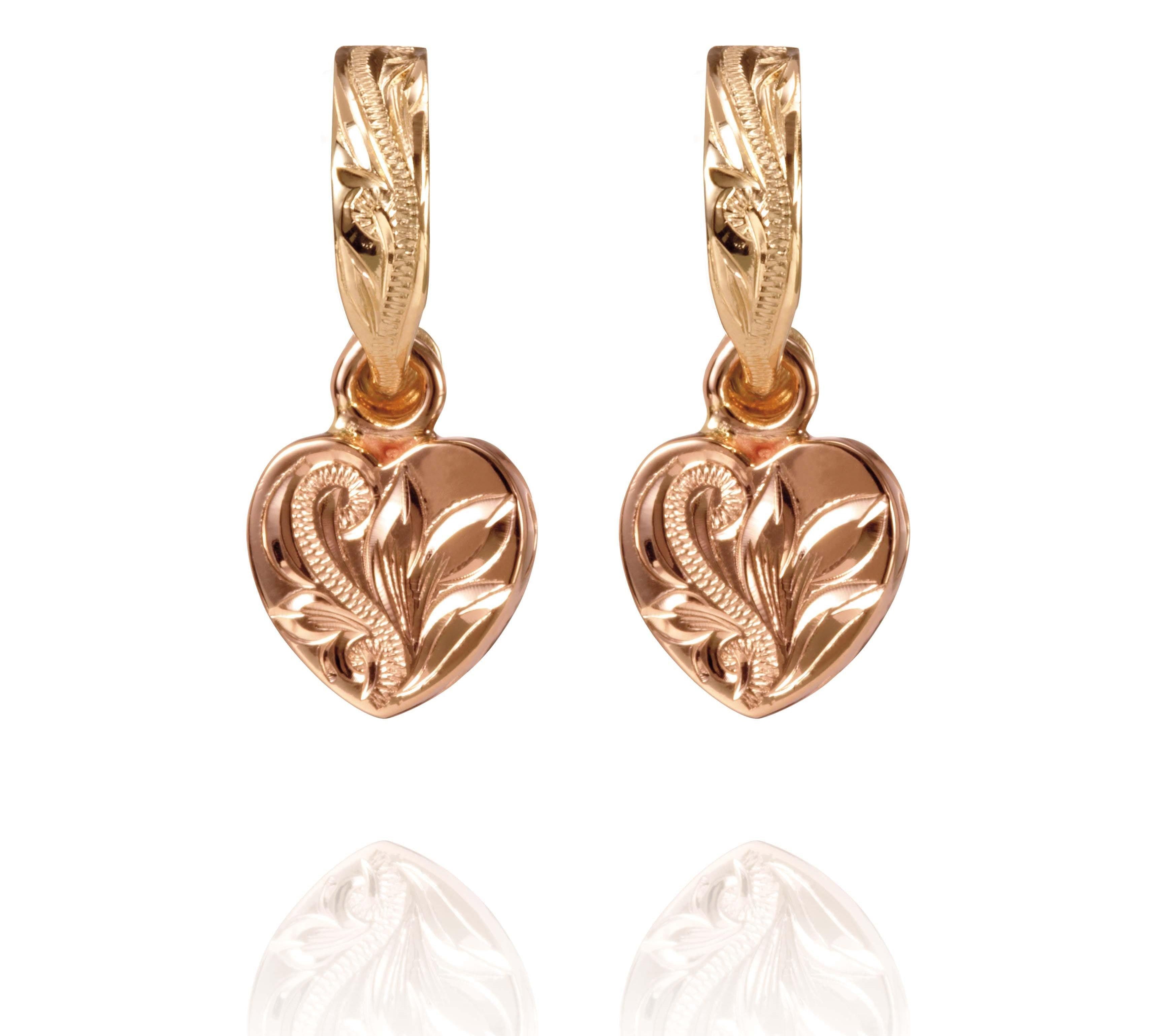 The picture shows a pair of 14K yellow and rose gold two-tone heart earrings with scroll engraving.