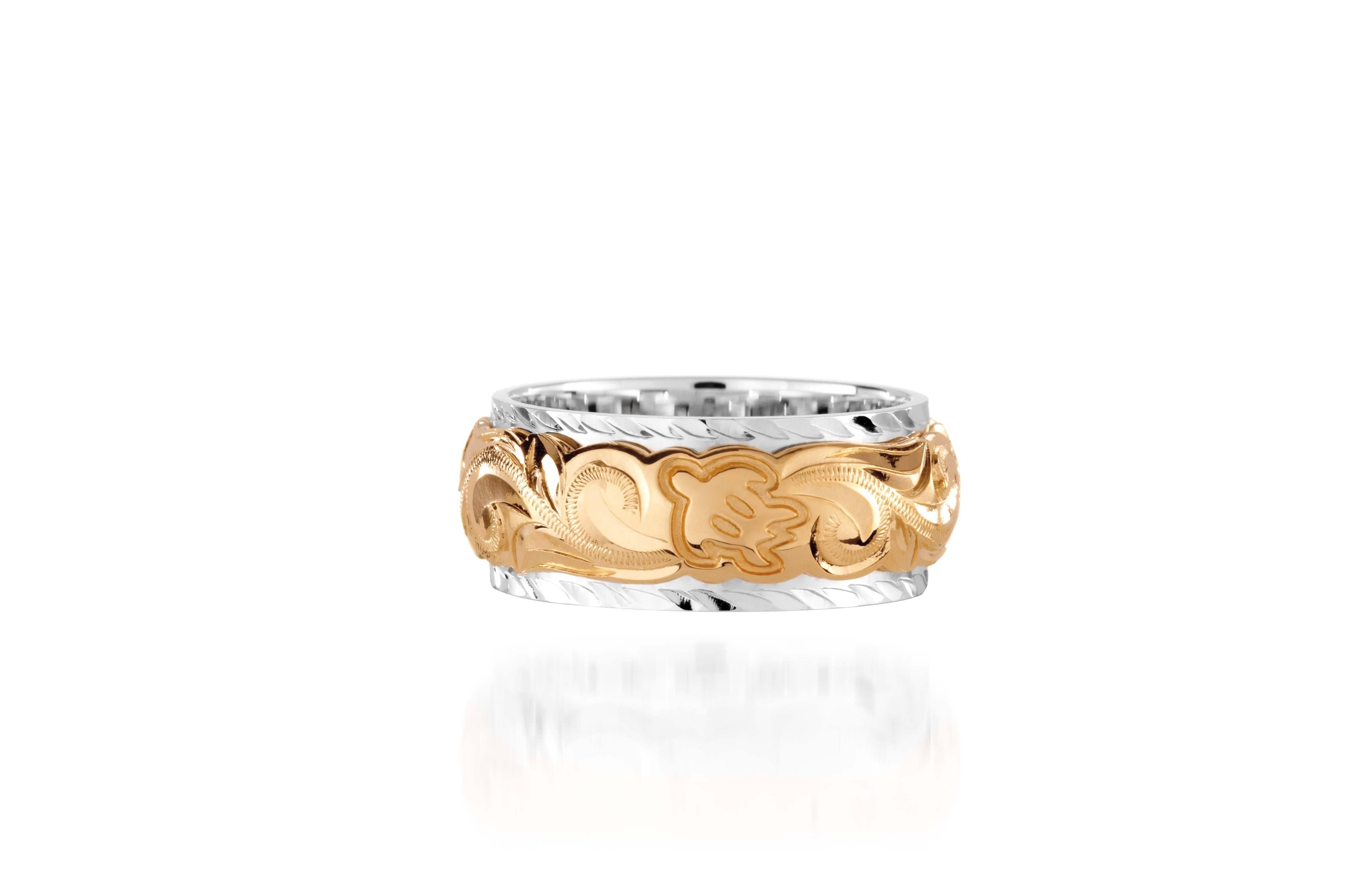 The photo shows a two-tone 8 mm 14K yellow and white gold ring with hand engravings including a sea turtle.