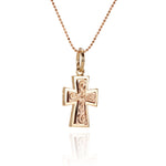 The picture shows a 14K yellow and rose gold two-tone cross pendant with hand engravings.